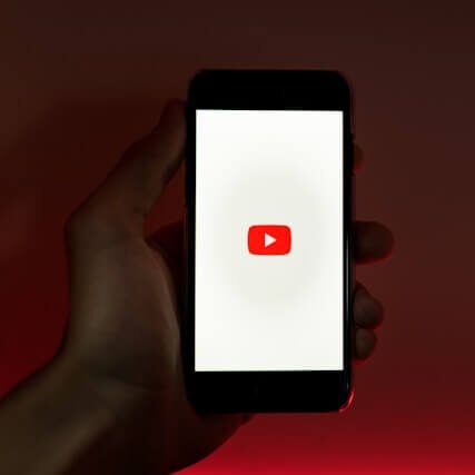 Man holding Smartphone with Youtube App opened